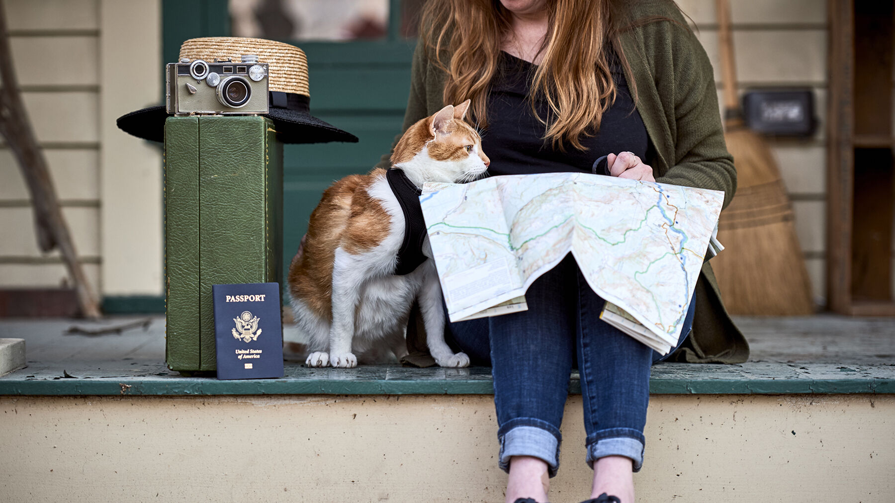 a girl looking at a map with her cat
